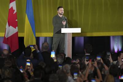 Ukrainian President Volodymyr Zelenskyy listens to an impromptu rendition of the Ukrainian national anthem at an event including members of the Ukrainian-Canadian community, in Toronto, on Friday, Sept. 22, 2023.