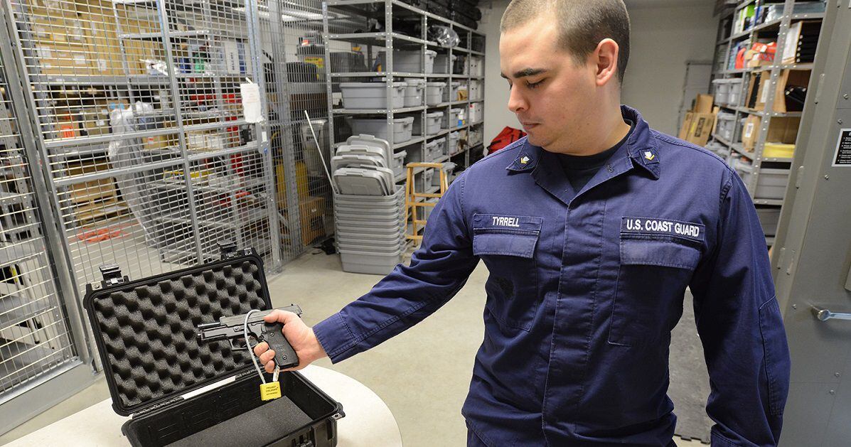 A person demonstrating the use of RFID technology with a smart gun and wearable activation device