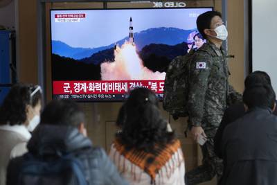 A South Korean army soldier passes by a TV screen showing a file image of North Korea's missile launch during a news program at the Seoul Railway Station in Seoul, South Korea, Wednesday, Nov. 2, 2022.