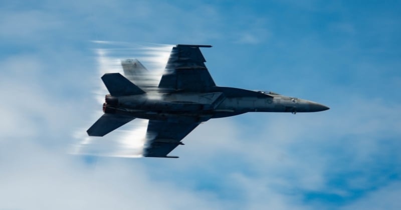An F/A-18E Super Hornet attached to the Eagles of Strike Fighter Squadron 115 breaks the sound barrier during an air power demonstration over the Philippine Sea Tuesday. (MCSA Oswald Felix Jr./Navy)