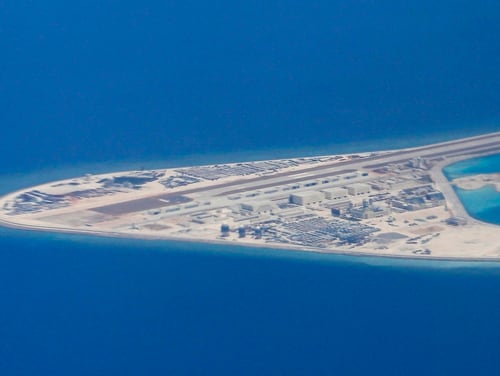 In this 2017 photo, Chinese structures and an airstrip on the man-made Subi Reef at the Spratly group of islands in the South China Sea are seen from a Philippine Air Force C-130. (Francis Malasig/Pool Photo via AP)