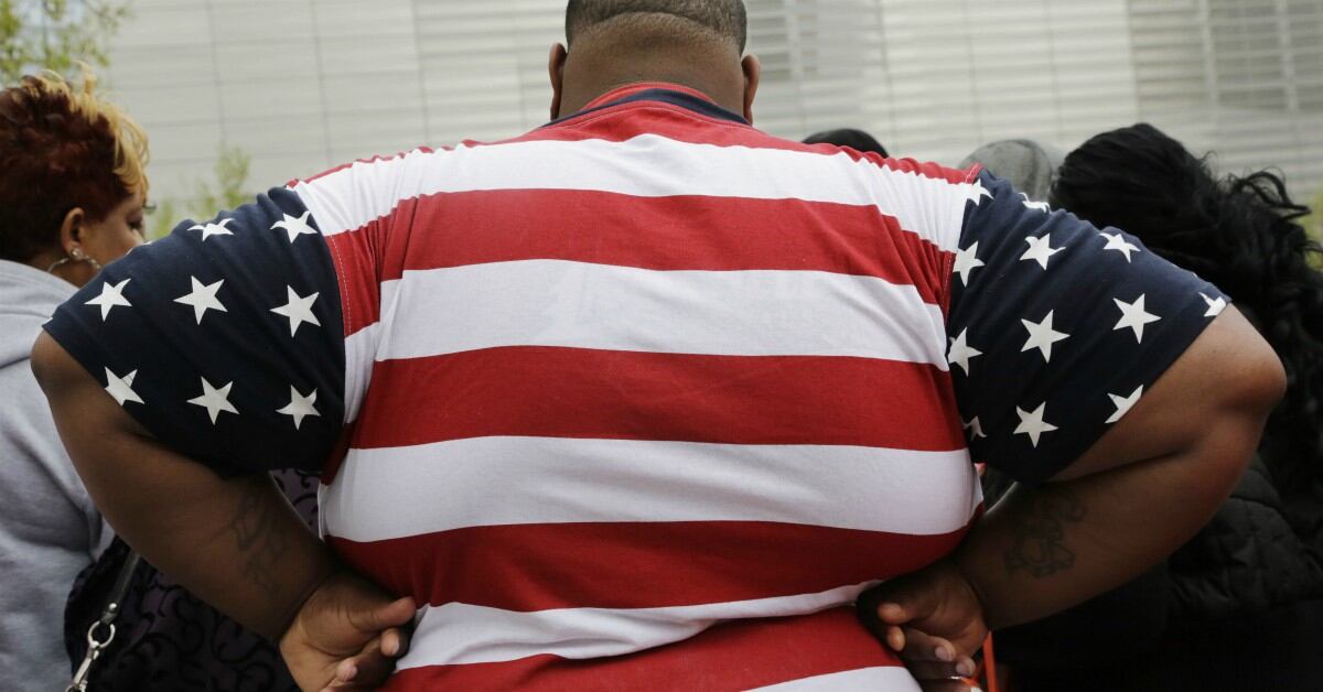 Obese retired US Army veteran with military medals on jacket, using walking cane for mobility support