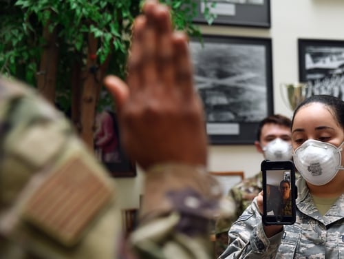 Major Yaira Nevarez, left, administers the enlistment oath to Sgt.  Jennifer Rogers during a virtual re-enlistment at Hanscom Air Force Base, Mass. (Linda LaBonte Britt / Air Force)