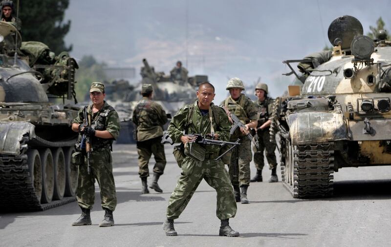 In this photo taken on Thursday, Aug. 14, 2008, Russian soldiers block the road on the outskirts of Gori, northwest of the capital Tbilisi, Georgia. Russia's Prime Minister Dmitry Medvedev in an interview broadcast by Russian state television Tuesday Aug. 7, 2018, on the 10th anniversary of the Russia-Georgia war, issued a stern warning that incorporating Georgia into NATO could trigger a new 