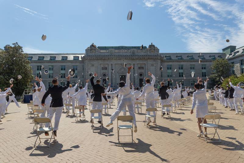 Midshipmen toss their covers May 14, 2020, concluding the second swearing-in event for the United States Naval Academy Class of 2020 in Annapolis, Md.