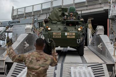 Soldiers assigned to the U.S. Army I Corps maneuver a Stryker combat vehicle off U.S. Naval Ship City of Bismarck while conducting roll-on-roll-off training at Naval Base Guam, Feb. 9, 2022.
