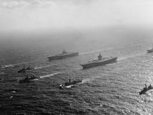 The aircraft carriers America, Enterprise and Oriskany cruise together in close formation in the South China Sea on Jan. 28, 1973 (Photo courtesy of the National Archives)