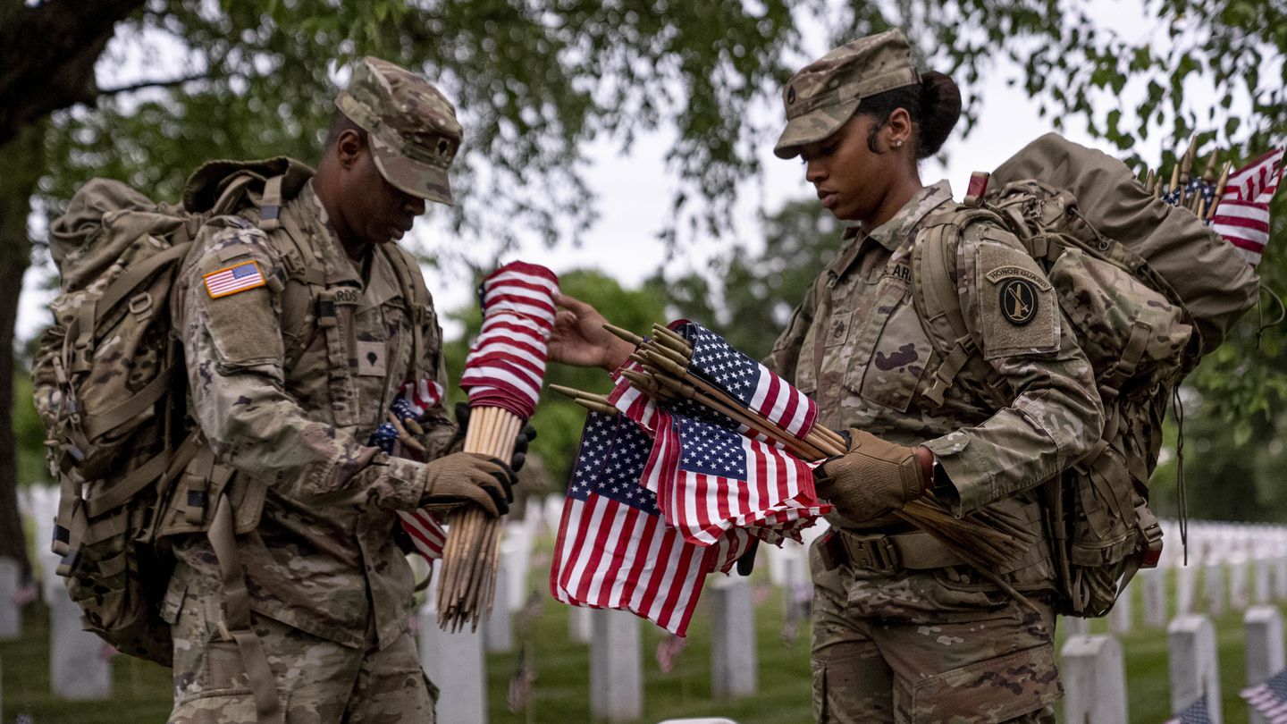 Members of the 3rd U.S. Infantry Regiment also known as The Old Guard, place flags in front of each headstone for 