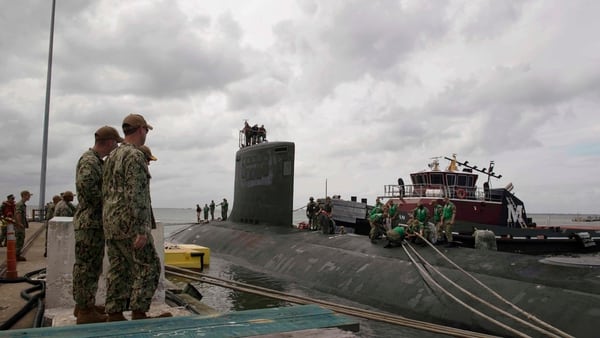 Sailors assigned to the Virginia-class attack submarine Indiana secure mooring lines to the sub. (MC2 Sonja Wickard/U.S. Navy)