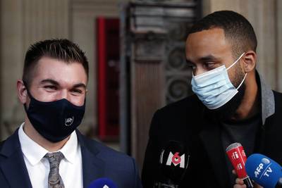 Alek Skarlatos, left, and Anthony Sadler, right, deliver a speech during the Thalys attack trial at the Paris courthouse, Friday, Nov. 20, 2020.