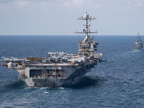 The carrier Harry S. Truman and the cruiser Normandy transit the Atlantic Ocean. Truman's deployment has been extended to avoid having it pull into port amid a global pandemic. (US Navy photo by MC2 Scott Swofford)