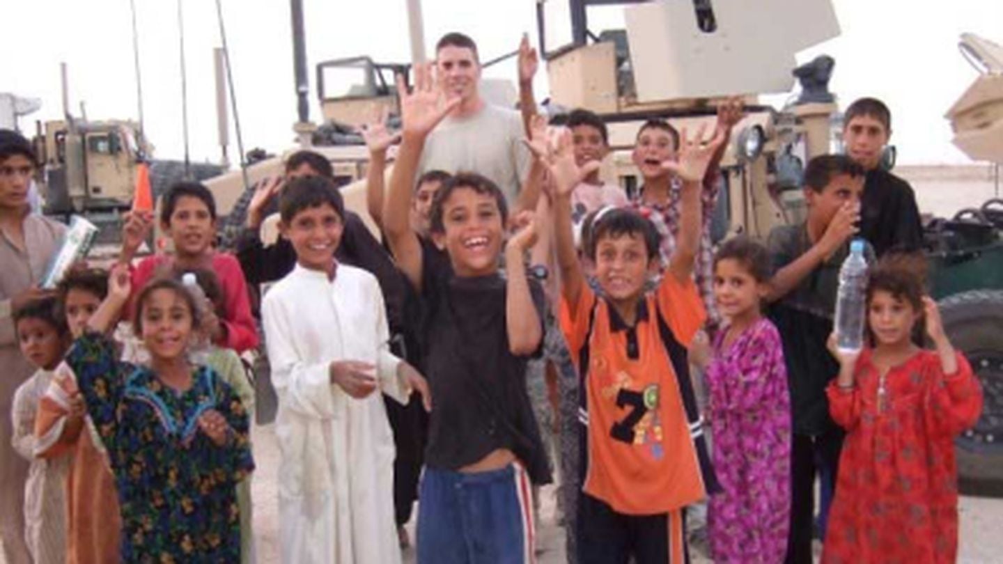 Mike Donahue hanging out with kids around the Um Eneej village outside the old Radio Relay Point 10’ in Iraq in 2008. Photo courtesy of the author.