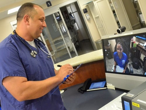 Lt. Michael White, a nurse at Naval Hospital Jacksonville’s intensive care unit, talks to Tiffany Ingram, a nurse at Naval Medical Center San Diego, during a patient care meeting on June 5, 2019. (Jacob Sippel/Navy)