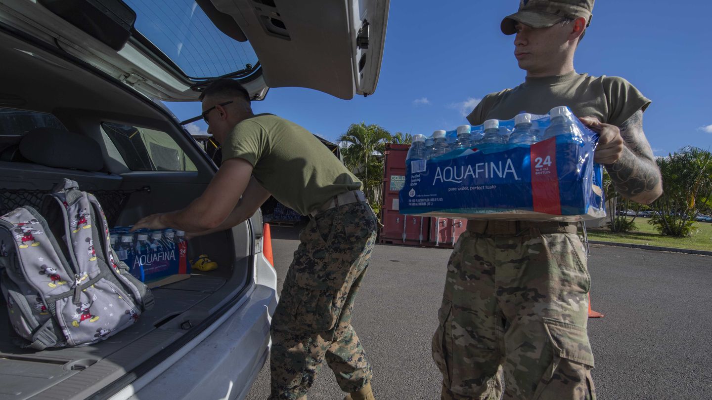 Service members pass out water at a Joint Base Pearl Harbor-Hickam water distribution center in 2022. (U.S. Navy Photo by Mass Communication Specialist Seaman Christopher Thomas)