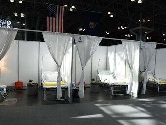 Patient care units, assembled by New York Army National Guard members and civilian staff, at the Jacob K. Javits Convention Center in New York City March 27, 2020. The convention center will be an alternate care site to ease the bed shortage of New York Hospitals as part of the state response to the COVID-19 outbreak (U.S. Air National Guard photo by Senior Airman Sean Madden)