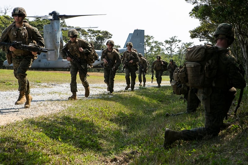 Marines with Charlie Company, Battalion Landing Team, 1st Battalion, 4th Marines, run toward security positions as part of the 31st Marine Expeditionary Unit's simulated Expeditionary Advanced Base Operations, at Camp Schwab, Okinawa, Japan, March 13. (Gunnery Sgt. T.T. Parish/Marine Corps)
