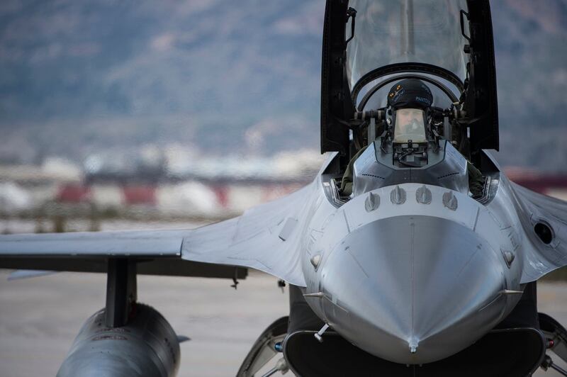 A U.S. Air Force pilot prepares for flight in an F-16 Fighting Falcon fighter aircraft during a flying training deployment on the flightline at Souda Bay, Greece, in January 2016. (Staff Sgt. Christopher Ruano/Air Force)