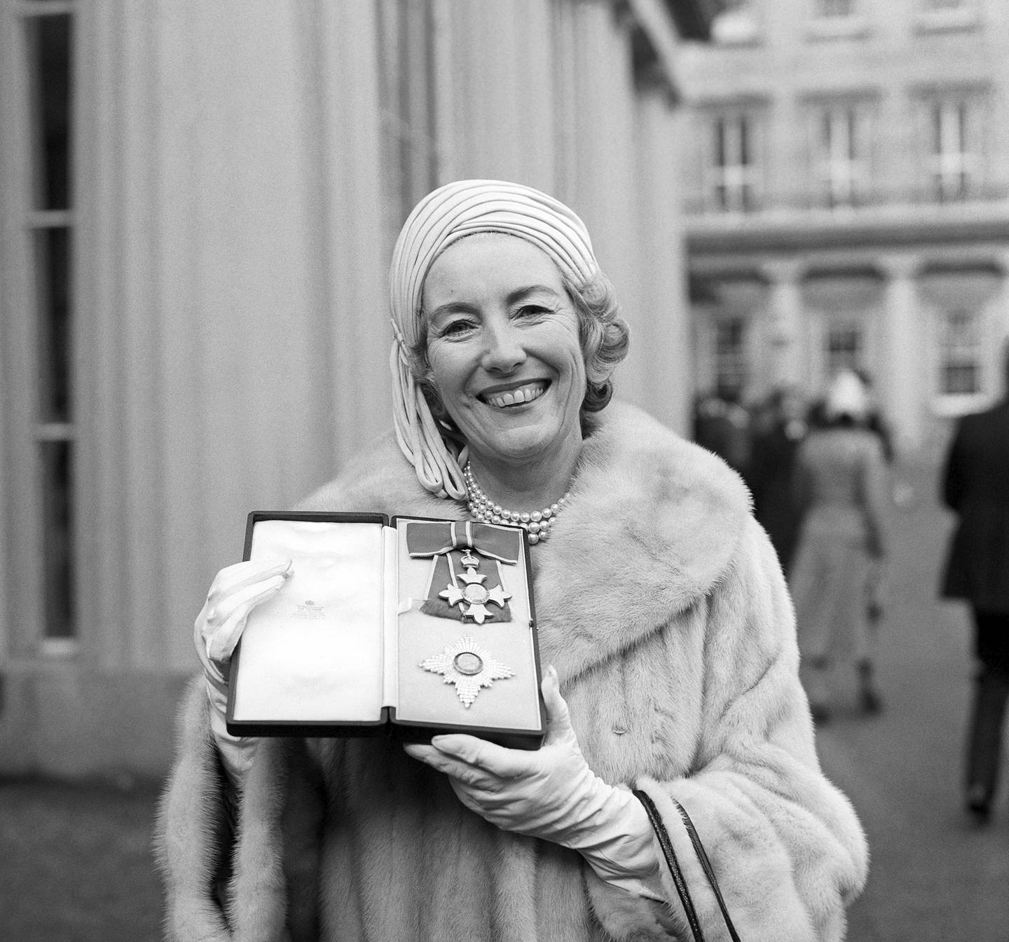 In this Dec. 2, 1975, file photo, singer Vera Lynn poses outside Buckingham Palace after being invested a Dame Commander of the British Empire.