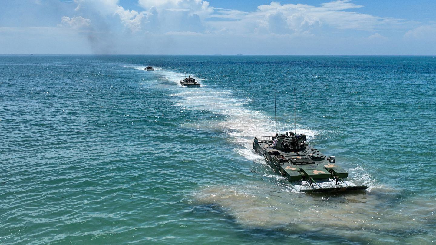 Amphibious assault vehicles of the Chinese People's Liberation Army move in formation at sea during a live-fire training exercise held in 2023. (Xie Wenjian/Chinese Defense Ministry)