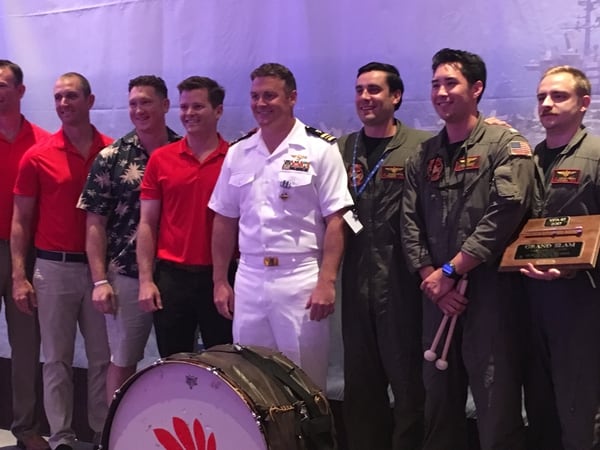 Navy Lt. Cmdr. Michael Tremel, center in white, poses for photos with buddies from Strike Fighter Squadron 87. Tremel received the Distinguished Flying Cross last week for shooting down a Syrian jet last summer. (Navy Times/Geoff Ziezulewicz)