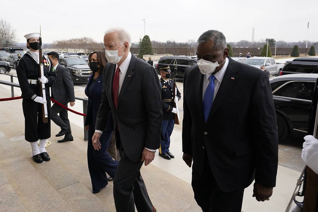 President Joe Biden and Vice President Kamala Harris walk with Secretary of Defense Lloyd Austin at the Pentagon, Wednesday, Feb. 10, 2021, in Washington.