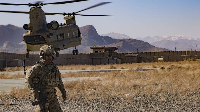 U.S. Army Capt. Bradley D. Rager, assigned to the Headquarters and Headquarters Battalion, 1st Armored Division, helps secure the helicopter landing zone as a CH-47 Chinook helicopter prepares to land at an Afghan military base Dec. 14, 2019, in southeastern Afghanistan.