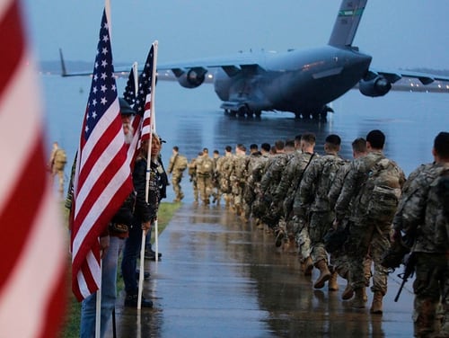 Paratroopers assigned to 1st Brigade Combat Team, 82nd Airborne Division walk as they prepare equipment and load aircraft bound for the U.S. Central Command area of operations from Fort Bragg, N.C., Saturday, Jan. 4, 2020. (Spc. Hubert Delany III/U.S. Army via AP)