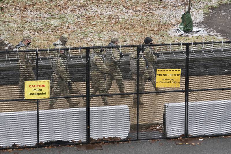 National Guard troops patrol the grounds of the Capitol in Washington, Tuesday, Jan. 26, 2021.
