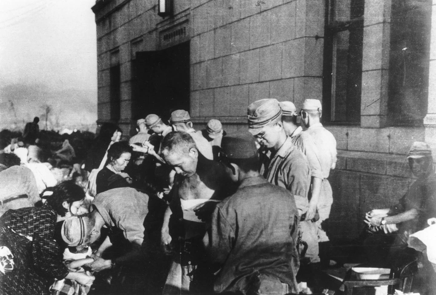 In this Aug. 6, 1945, file photo, survivors are seen as they receive emergency treatment by military medics shortly after the first atomic bomb ever used in warfare was dropped by the United States over Hiroshima, Japan.