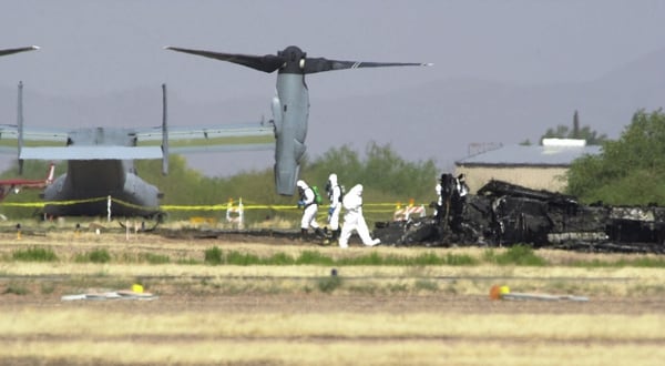 Workers investigate the crash scene of a Marine MV-22 Osprey north of Tucson, Ariz., on April 9, 2000. (Jon Hayt/Associated Press)