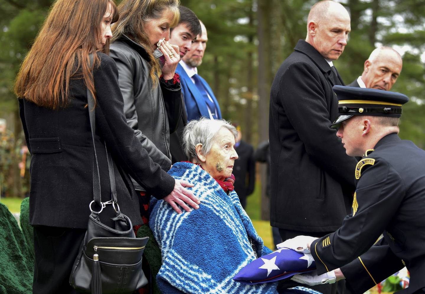 Patricia Lyons, 90, the only remaining sibling of Army Sgt. Alfred Sidney, is handed the American flag from his burial service in Littleton, N.H., on Thursday, Dec. 8, 2022.