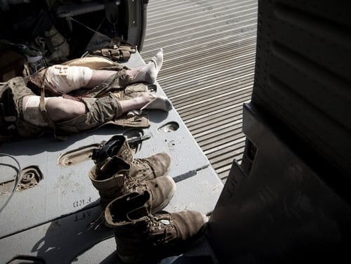 A wounded US Marine, who was hit by an Improvised Explosive Device (IED) lays in the medevac helicopter of U.S. Army's Task Force Lift 