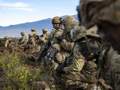 Soldiers with 2nd Squadron, 14th Cavalry Regiment, 2nd Infantry Brigade Combat Team, 25th Infantry Division get ready to bound forward during a fire support coordination exercise Nov. 19, 2019 at Pohakuloa Training Area on the island of Hawaii.