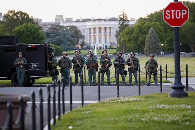 Law enforcement officers from Calvert County Maryland Sheriff's Office standing on the Ellipse, area just south of the White House in Washington, as they watch demonstrators protest the death of George Floyd, Sunday, May 31, 2020. Floyd died after being restrained by Minneapolis police officers. (Alex Brandon/AP)