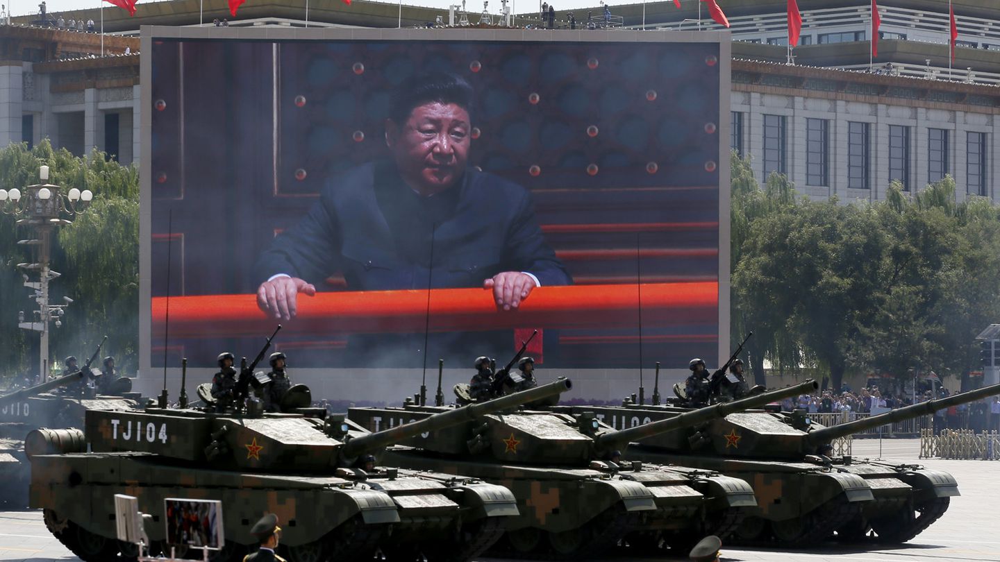 Chinese President Xi Jinping is displayed on a screen as Type 99A2 battle tanks participate in a 2015 parade in Beijing. (Ng Han Guan/AP)