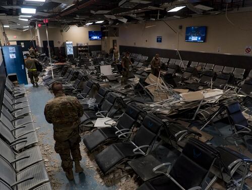 U.S. Air Force airmen work together to clear debris inside the passenger terminal the day after a Taliban-led attack at Bagram Airfield, Afghanistan, Dec. 12, 2019. (Airman 1st Class Brandon Cribelar/Air Force)