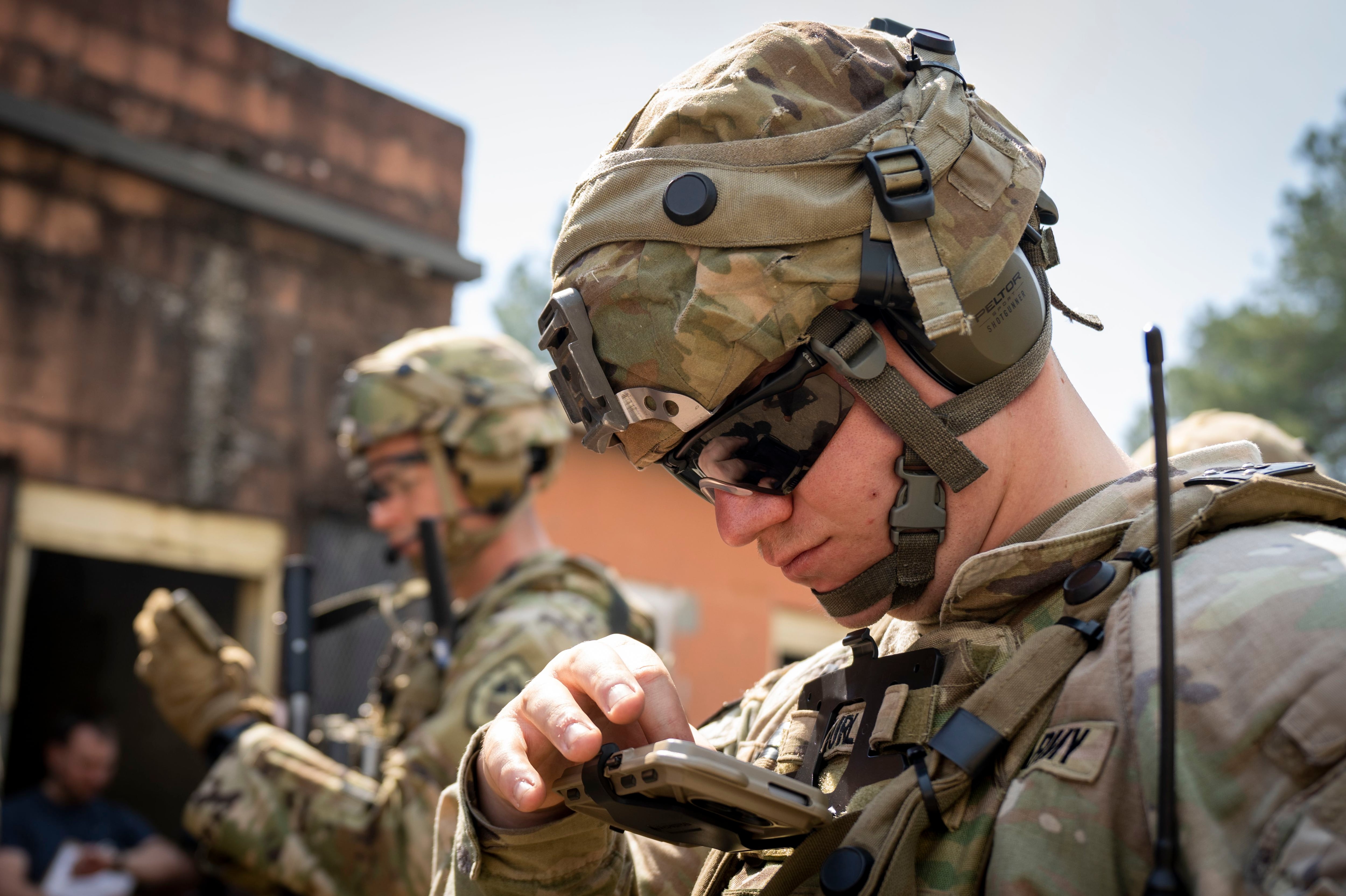 Soldiers check their Nett Warrior devices during a 2021 Army experiment held on Fort Benning, Ga. (Jason Amadi/U.S. Army)