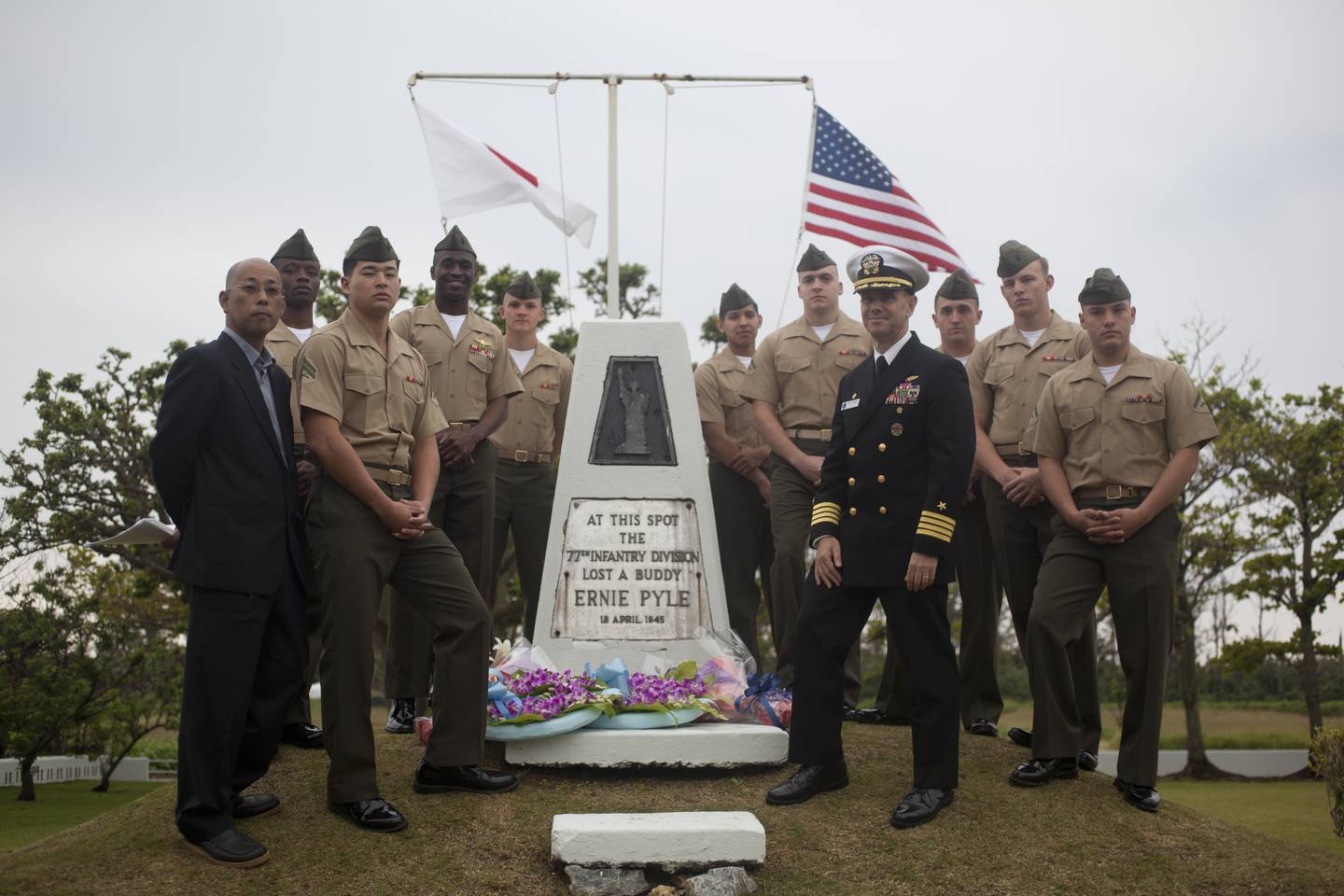 U.S. service members and an Okinawan pose for a photo at the Ernie Pyle Memorial after the memorial ceremony on Ie Shima, Okinawa, Japan, April 14, 2013.