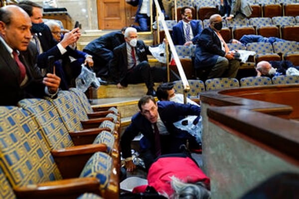 People shelter in the House gallery as protesters try to break into the House Chamber at the U.S. Capitol on Jan. 6, 2021, in Washington. (Andrew Harnik/AP)