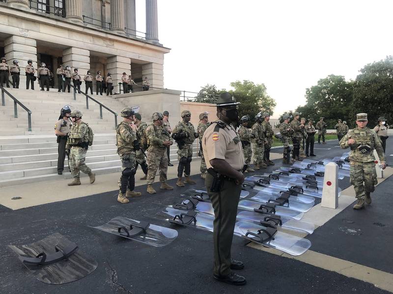 National Guard troops lay down their shields at the request of protesters in Nashville, Tenn., Monday, June 1, 2020.