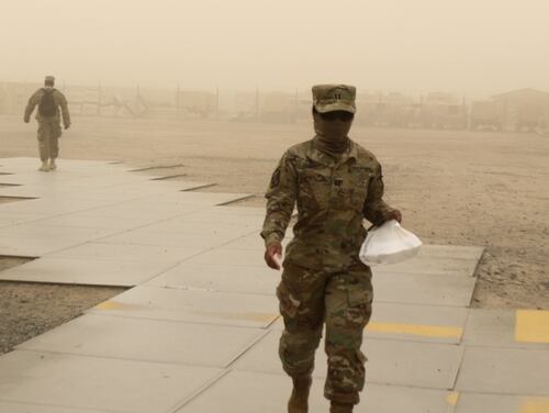 A service member at Camp Arifjan, Kuwait, wears a neck gaiter as a face mask. (Sgt. Connie Jones/Army)