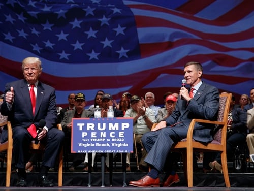 Then-presidential candidate Donald Trump gives a thumbs up as he speaks with retired Lt. Gen. Michael Flynn during a town hall on Sept. 6, 2016, in Virginia Beach, Va. On Wednesday, Trump pardoned Flynn for lying to the FBI about his contacts with Russian operatives during the transition to the Trump presidency in 2016. (Evan Vucci/AP)