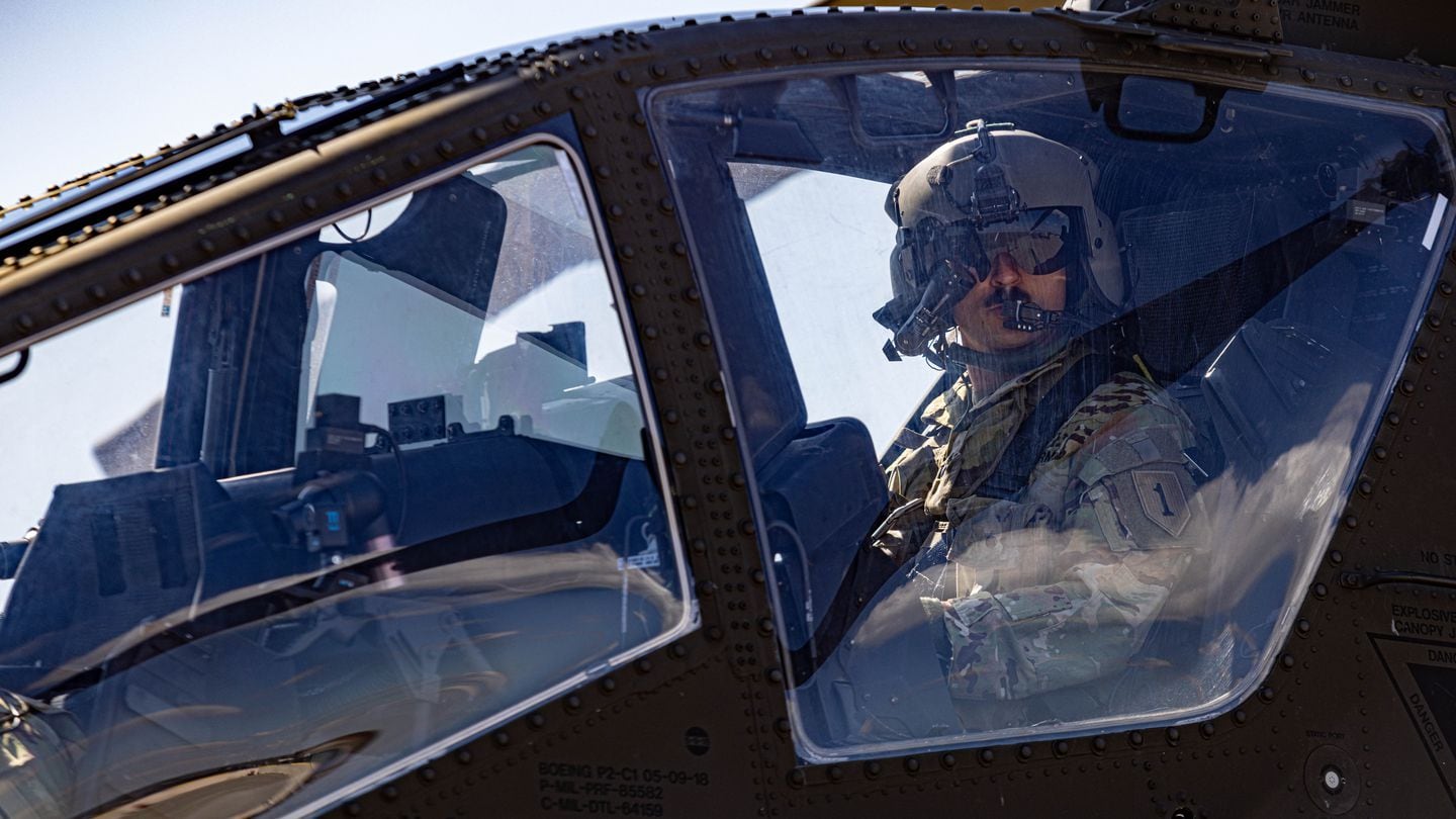 U.S. Army Warrant Officer Troy Deckert Jr., an AH-64 Apache pilot, performs a preflight check before going on a training flight in Romania on March 26, 2024. (Spc. Nolan Brewer/U.S. Army)