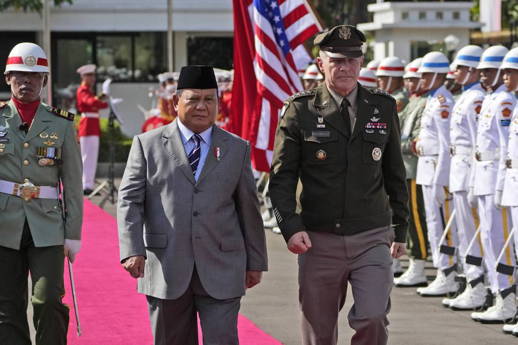 U.S. Army Chief of Staff Gen. James McConville, right, and Indonesian Defense Minister Prabowo Subianto inspect an honor guards during their meeting in Jakarta, Indonesia, Friday, May 12, 2023.