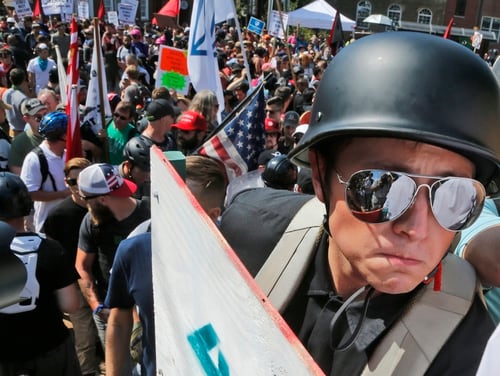 A demonstrator walks into Lee Park in Charlottesville, Virginia., Aug. 12, 2017. Hundreds of people chanted, threw punches, hurled water bottles and unleashed chemical sprays on each other after violence erupted at a white nationalist rally in Virginia. (Steve Helber/AP)