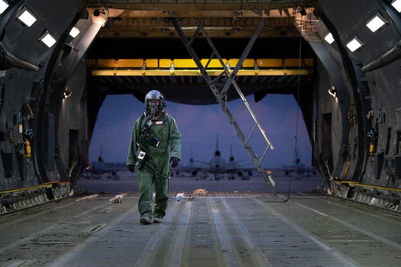 Staff Sgt. Cameron DiMatteo, 22nd Airlift Squadron loadmaster, walks inside a C-5M Super Galaxy during a base exercise Nov. 18, 2020, at Travis Air Force Base, Calif.