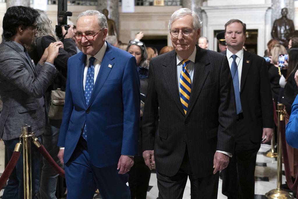 Senate Majority Leader Chuck Schumer, D-N.Y., left, accompanied by Senate Minority Leader Mitch McConnell, R-Ky., arrive for President Joe Biden's State of the Union address to a joint session of Congress at the Capitol, Tuesday, Feb. 7, 2023, in Washington.