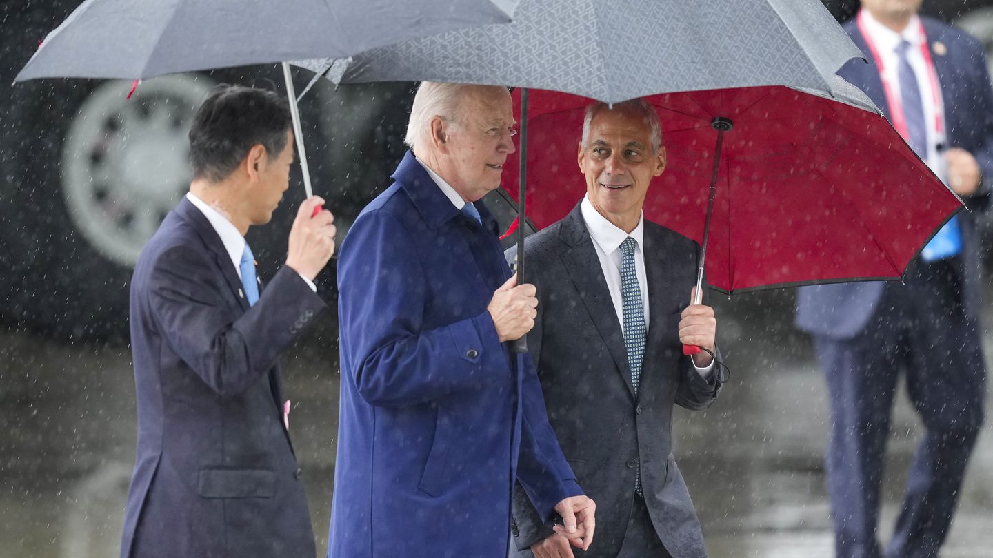 U.S. President Joe Biden, center, walks with Kenji Yamada, Japanese deputy minister of foreign affairs, left, and U.S. Ambassador to Japan Rahm Emanuel, right, after his arrival at Marine Corps Air Station Iwakuni, western Japan, Thursday, May 18, 2023, en route to Hiroshima for the Group of Seven nations' summit that starts Friday. (Hiro Komae/ap)