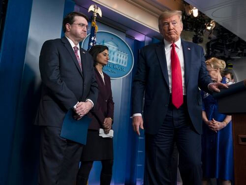 President Donald Trump departs after a press briefing with the coronavirus task force at the White House on March 18, 2020, as Veterans Affairs Secretary Robert Wilkie (left) looks on. (Evan Vucci/AP)