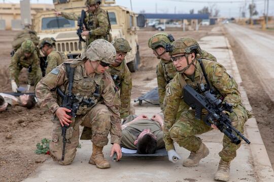 A U.S. soldier, left, and Australian soldiers carry a simulated casualty on a Talon Litter during a mass casualty training exercise at Camp Taji, Iraq, Feb. 1, 2020. (Spc. Caroline Schofer/Army)